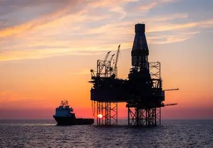 Offshore oil rig at sunset, representing Libya's energy sector